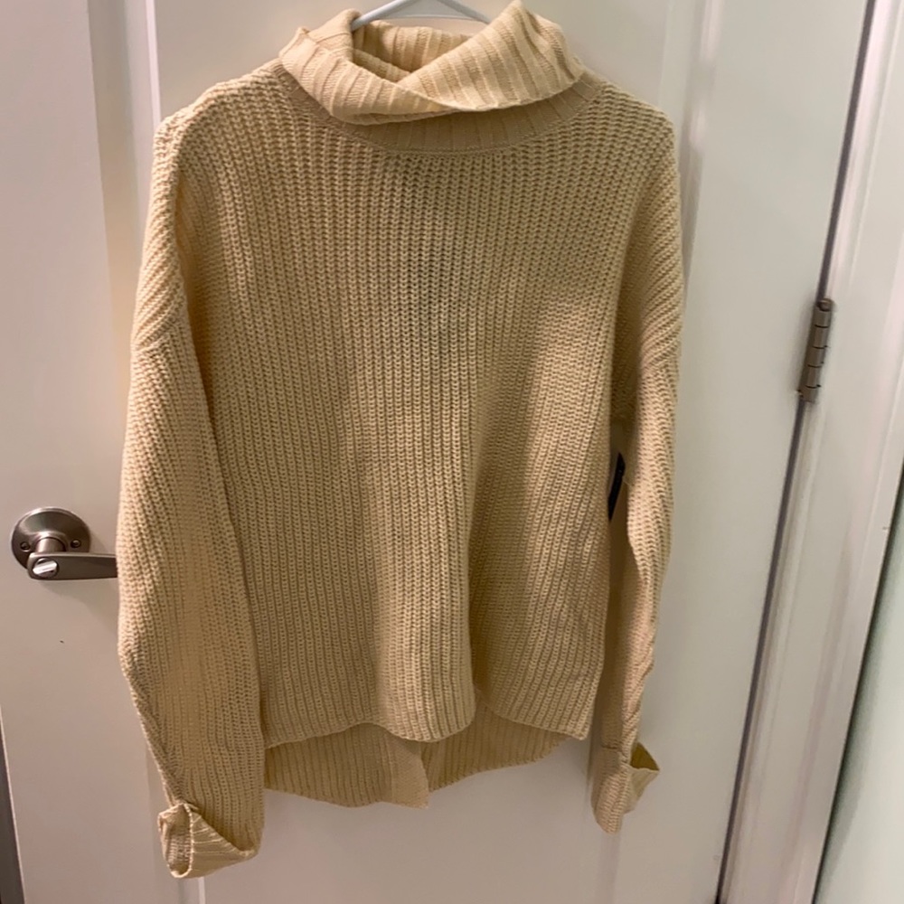 White cowl neck sweater with lace design on back